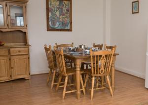 y cocina con mesa de comedor y sillas. en Moore Bay Holiday Homes, en Kilkee