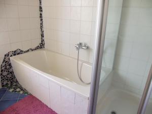 eine Badewanne mit Dusche im Bad in der Unterkunft Siggis Home in Wilhermsdorf