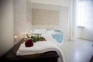 a bathroom with a bath tub and a white sink at Tenuta Torellone in San Potito Sannitico