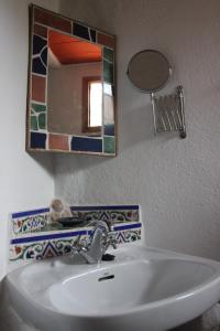 a bathroom with a sink and a mirror at Cinco Lunas Holiday Accommodation in Zahara de la Sierra