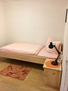 a bedroom with a bed and a lamp on a table at Landhaus Düngenheim in Düngenheim