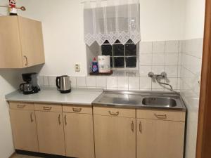 a kitchen with a sink and a counter top at Landhaus Düngenheim in Düngenheim +2 photos