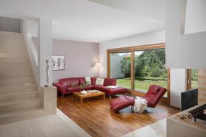 a living room with red furniture and a large window at Casa Vidmar in Klimno +14 photos