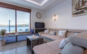a living room with a couch and a tv at Villa Ema in Čižići