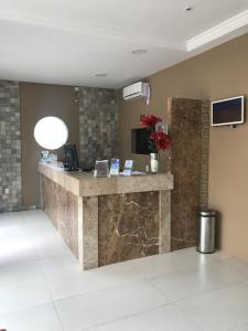 a lobby of a hotel with a reception counter at Hotel Aquarius in Fortaleza