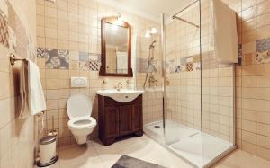 a bathroom with a toilet and a sink and a shower at Cozy Apartment in Braşov +104 photos