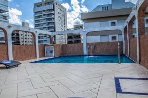 a swimming pool on top of a building at Atlantico Inn Apart Hotel in Santos