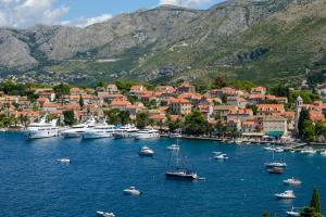 a group of boats in a harbor with a city at Apartments Nika in Cavtat