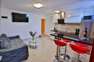 a kitchen and living room with a couch and a table at Luxury apartment M&N in Split in Split