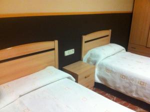 Voodi või voodid majutusasutuse Hotel Manises toas