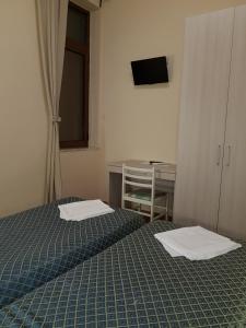 Postel nebo postele na pokoji v ubytování Hotel Il Quadrifoglio