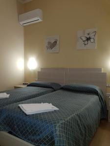 Postel nebo postele na pokoji v ubytování Hotel Il Quadrifoglio