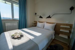 a bedroom with a bed with a plate of food on it at ZEN Residential Apartments in Cluj-Napoca +25 photos