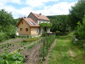 a house with a vegetable garden in front of it at chez Geppetto in Saint-Georges-Nigremont