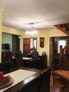 a living room with a dining room table and chairs at Casa de São Sebastião in Manteigas