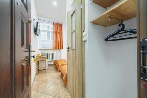a hallway leading to a bedroom with a bed at hostelswidnicka24 in Wrocław +26 photos