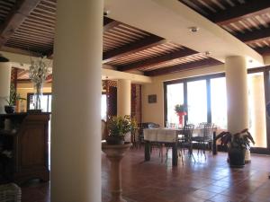 a dining room with a table and chairs at La Marine in Luri