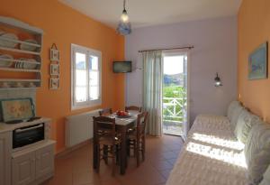 a bedroom with a table and a bed and a dining room at Korali apartments in Galissas