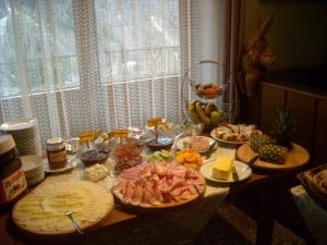 a table with many plates of food on it at Familienpension Gletscherblick in Heiligenblut