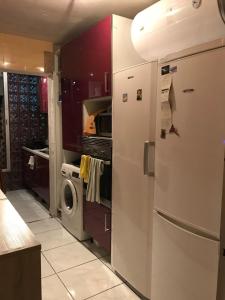 a kitchen with a refrigerator and a washing machine at Rooms Complex "Cristimar", Los Cristianos in Los Cristianos