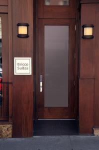 a wooden door with a sign that reads slice suites at Bricco Suites in Boston