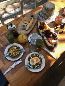 a wooden table with plates of food on it at Fenix Beach Cartagena in Tierra Bomba