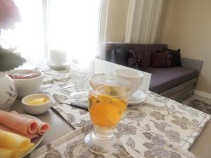 a table with a glass of orange juice on it at Casa 1 dormitório prox da praia in Itapema