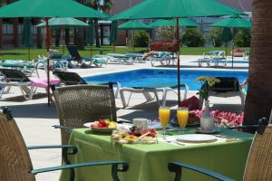 a table with fruit on it next to a pool at Hotel Clipper - EL DELFÍN VERDE RESORTS - Platja de Pals in Torroella de Montgrí