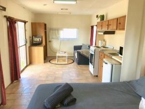 a room with a kitchen and a living room at Cute Private Studio Flat with AIRCON! in Hay