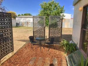 a patio with two chairs and a table at Cute Private Studio Flat with AIRCON! in Hay