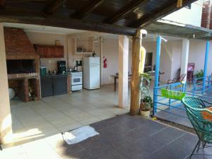 a kitchen with a refrigerator and a table at Fariña hospedajes in Puerto Iguazú