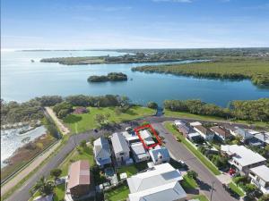 an aerial view of a lake with houses and a road at Absolute Waterfront in Brisbane