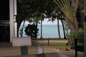 a view of the ocean from the porch of a house at Whitehaven Beachfront Holiday Units in Airlie Beach