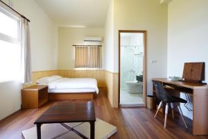 Postel nebo postele na pokoji v ubytování Penghu Sun House