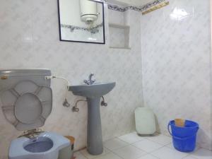 a bathroom with a toilet and a sink at Ashish Marriage Place in Jaipur
