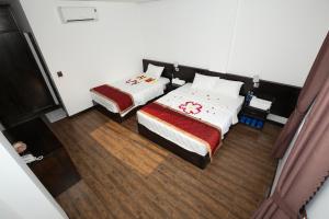 a bedroom with two beds and a television at Thanh Vy Hotel in Phu Quoc +43 photos