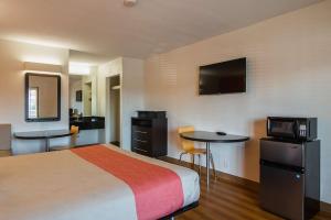a hotel room with two beds and a television at Motel 6-Savannah, GA - Midtown in Savannah