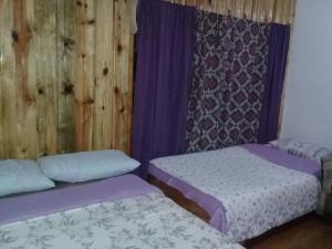 
A bed or beds in a room at Big Dipper Sagada
