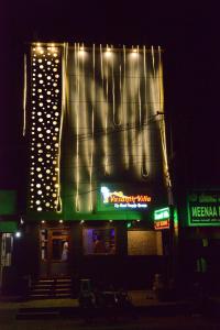 a building with lights on top of it at night at Vasanth Villa in Kanchipuram