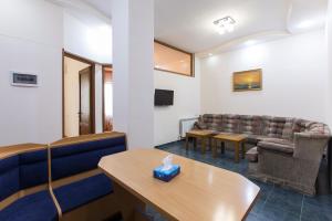 a waiting room with couches and a table at Umba Apartment N1 - 2 bedrooms in Yerevan +14 photos