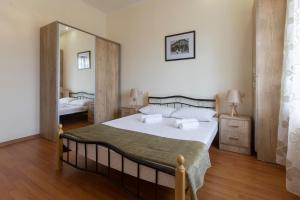 a bedroom with a bed and a large mirror at Umba Apartment N1 - 2 bedrooms in Yerevan