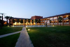 a campus at night with a lawn and a building at Hotel Clipper - EL DELFÍN VERDE RESORTS - Platja de Pals in Torroella de Montgrí