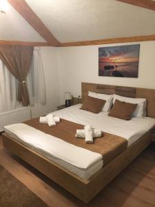 a bedroom with a large bed with towels on it at Bed and Breakfast Divanhana in Novi Pazar