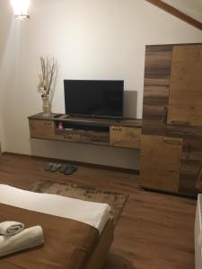 a living room with a flat screen tv on a entertainment center at Bed and Breakfast Divanhana in Novi Pazar