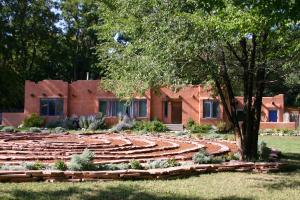 a garden in front of a building at Adobe and Pines Inn Bed and Breakfast in Taos +36 photos