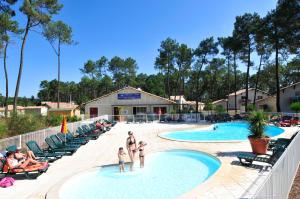 um grupo de pessoas na piscina de um resort em Résidence Goélia Les Demeures du Lac em Casteljaloux