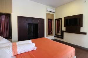 Postel nebo postele na pokoji v ubytování Kondra Premiere Guest House Kuta