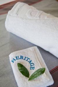 a towel with the word merida on it next to a towel with a leaf at Voyager Ziwani Tented Camp in Ziwani