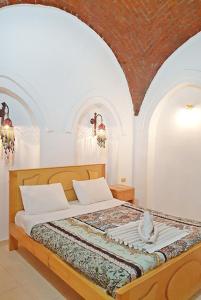 Postel nebo postele na pokoji v ubytování Hotel Sheherazade Luxor