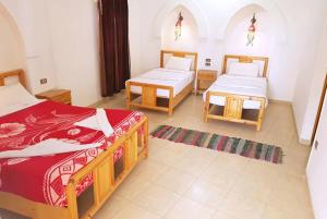 Postel nebo postele na pokoji v ubytování Hotel Sheherazade Luxor